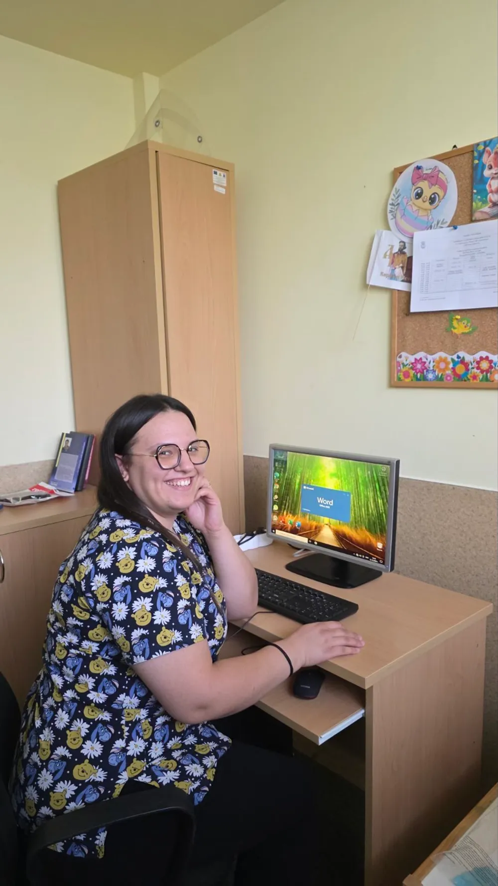 Служителка на комплекса на работното си място с новия компютър